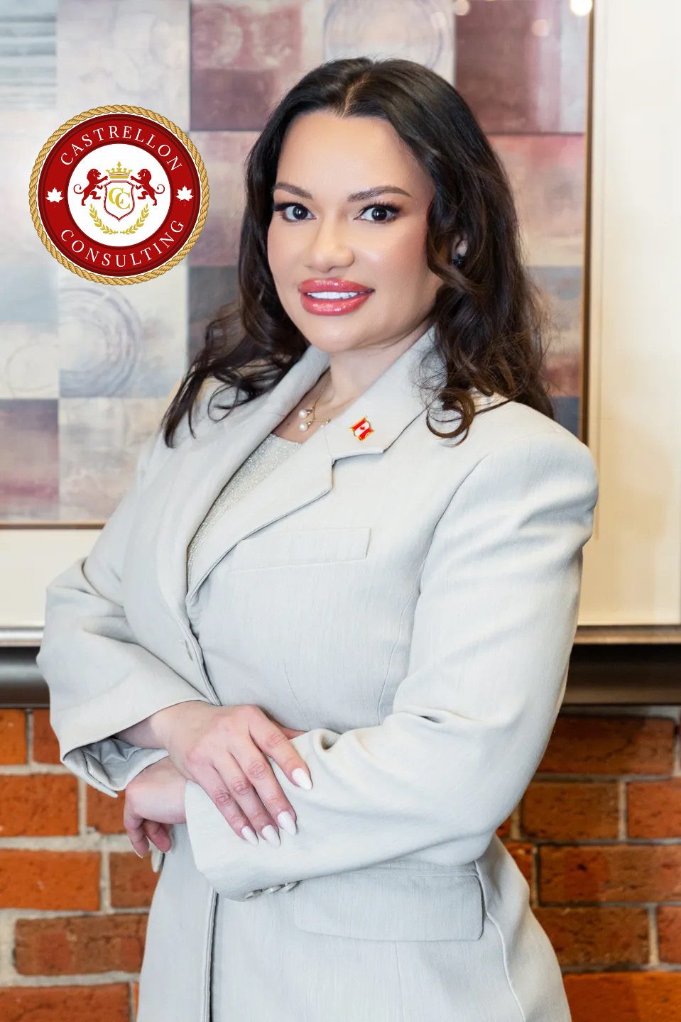 Professional woman in a light gray suit smiling confidently.