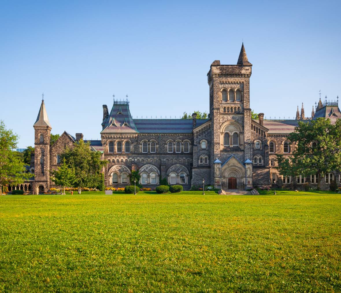 Historic university building with green lawn